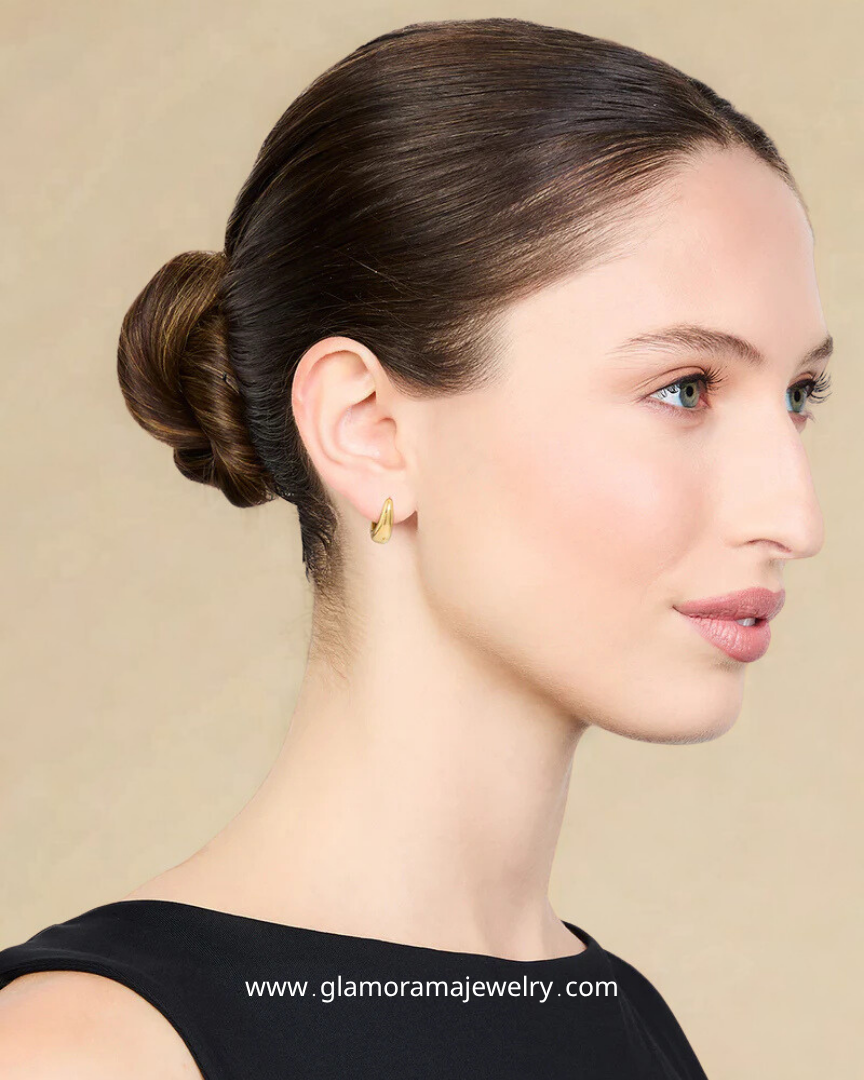 Woman wearing gold earrings glamorama jewelry
